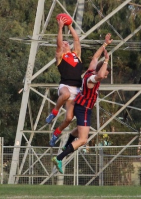 Dingo Robbie Rusan climbs high over Panther Ryan Mullett to reel in a screamer.