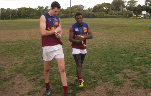 Chris Mwaba (right) walks off the ground following last week's match against Black Rock.
